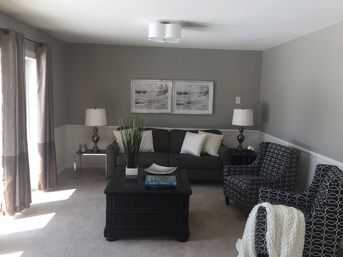 A living room with a couch , chairs and a coffee table