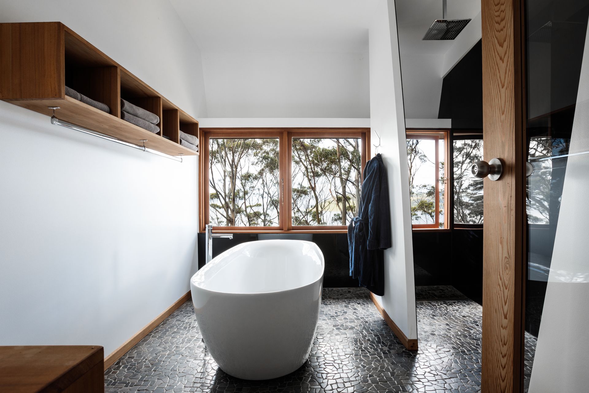 There is a bathtub in the middle of the bathroom.