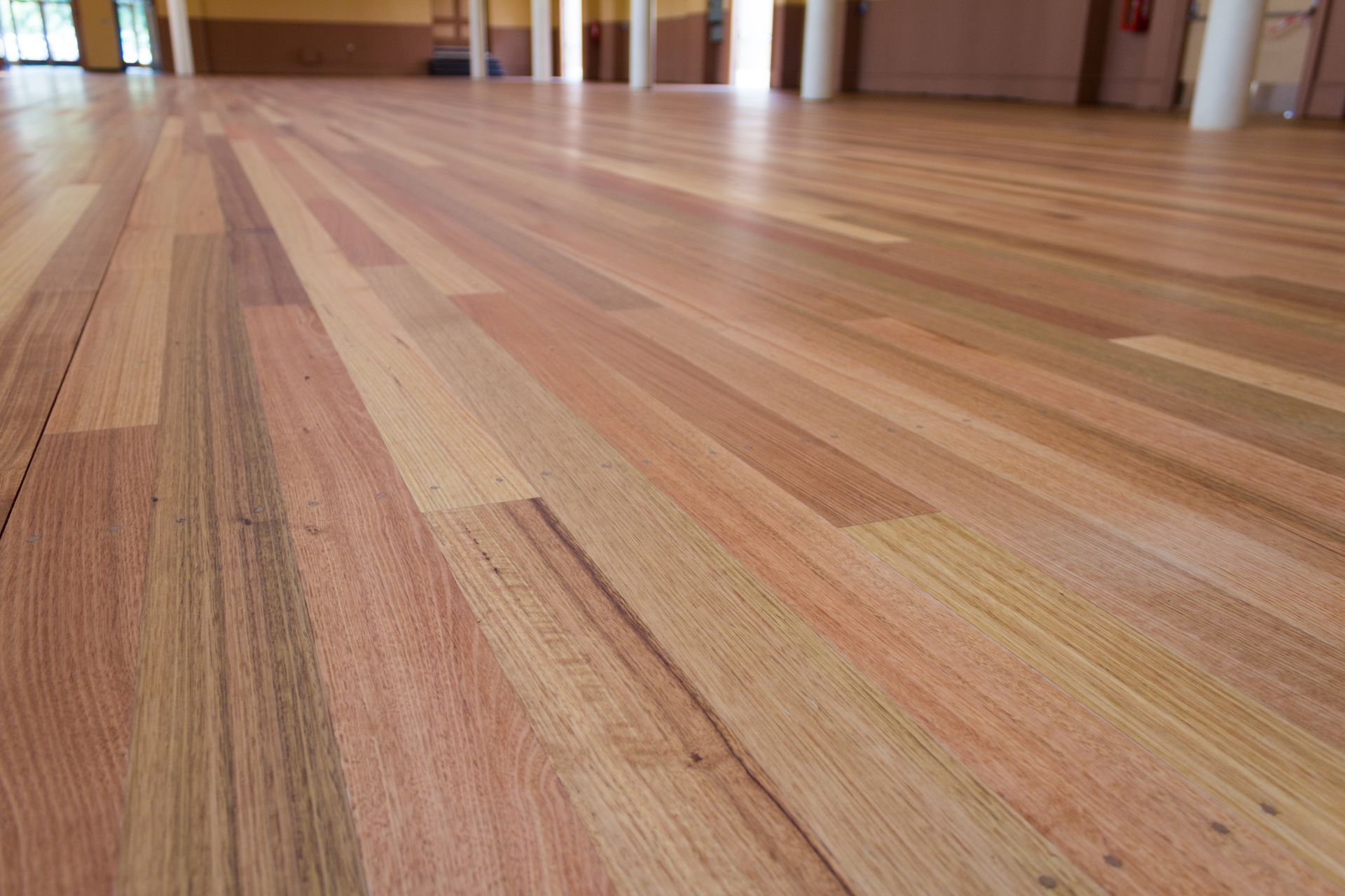 A close up of a wooden floor in an empty room