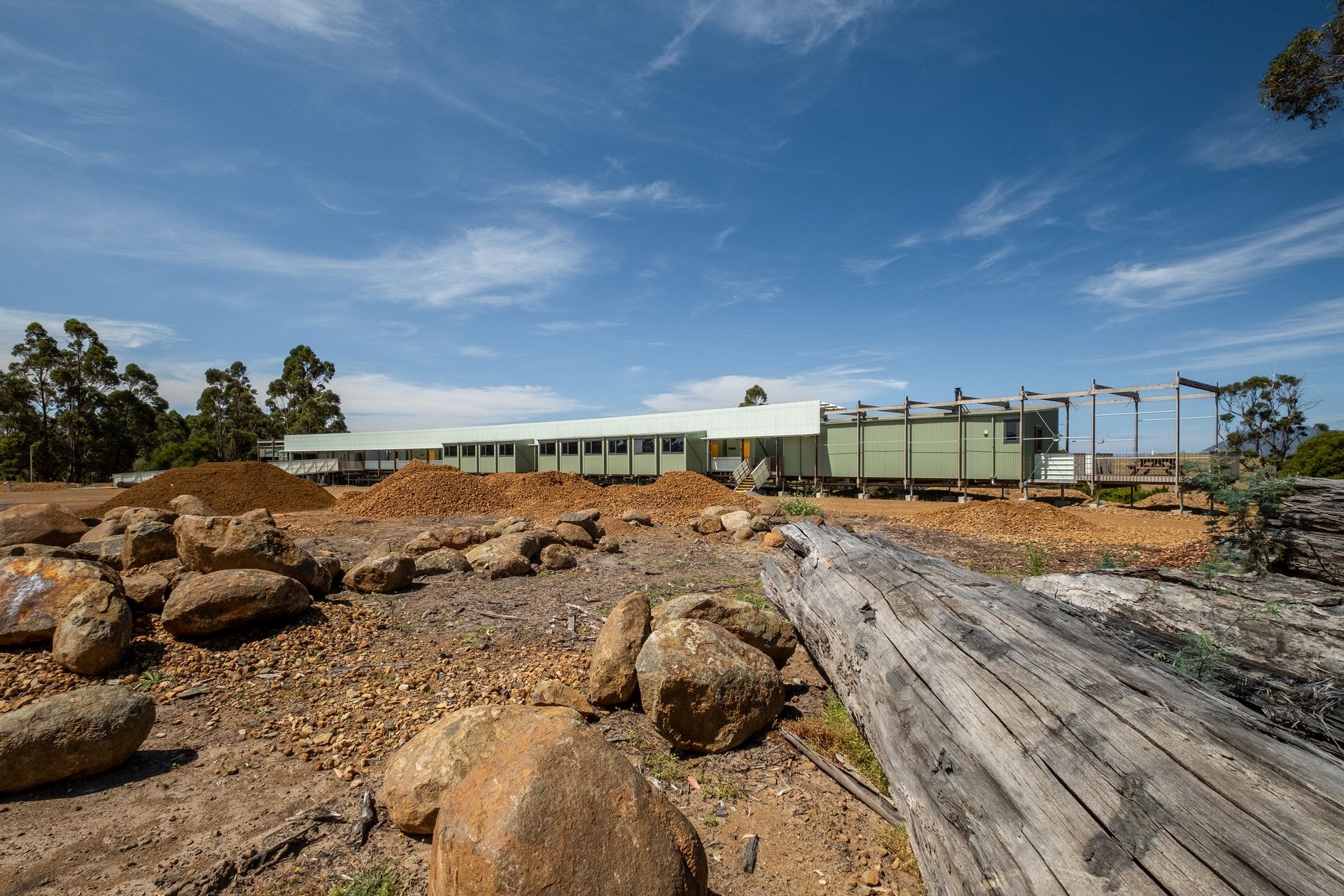 A large building with a lot of rocks in front of it.