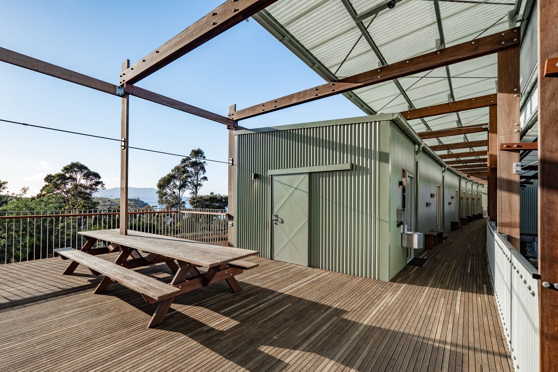 A wooden deck with a picnic table on it