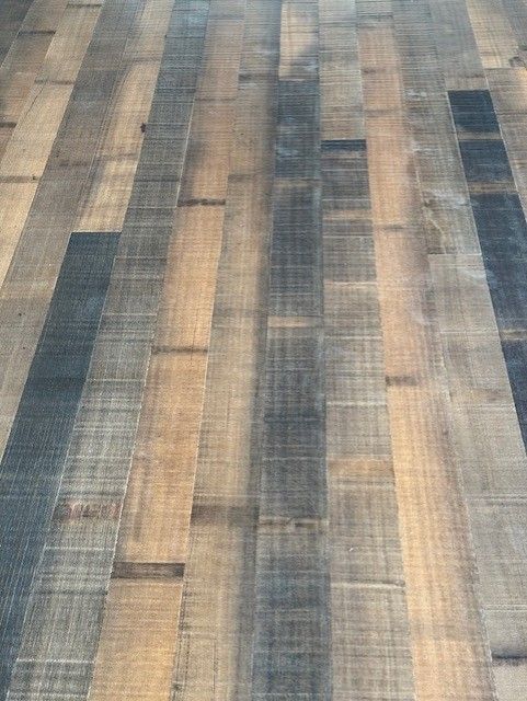 A close up of a wooden floor with a striped pattern.