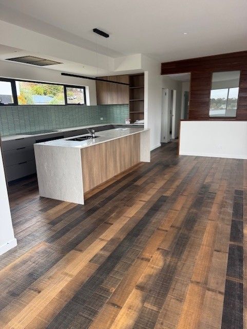 A kitchen with wooden floors and a large island