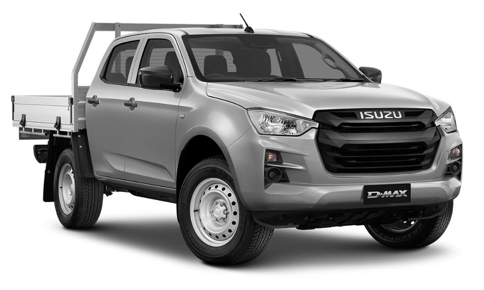 a row of cars are parked in a lot in front of a building .