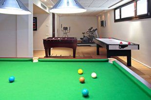 For new rooms in Plymouth call Hocking Garage Conversions Games room with a gym, air hock, football table and a snooker table