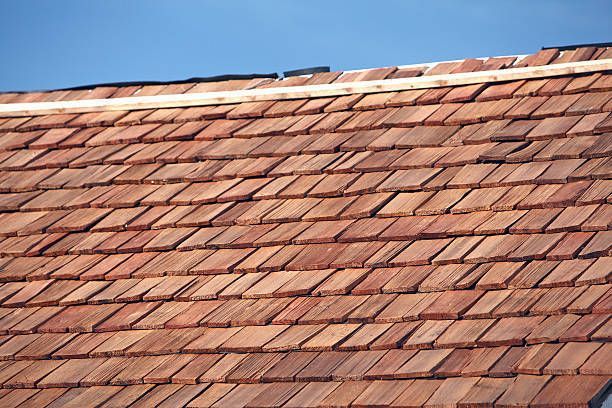 A Close Up Of A Wooden Tiled Roof With A Blue Sky In The Background — Pittsfield, MA — ML Contracting