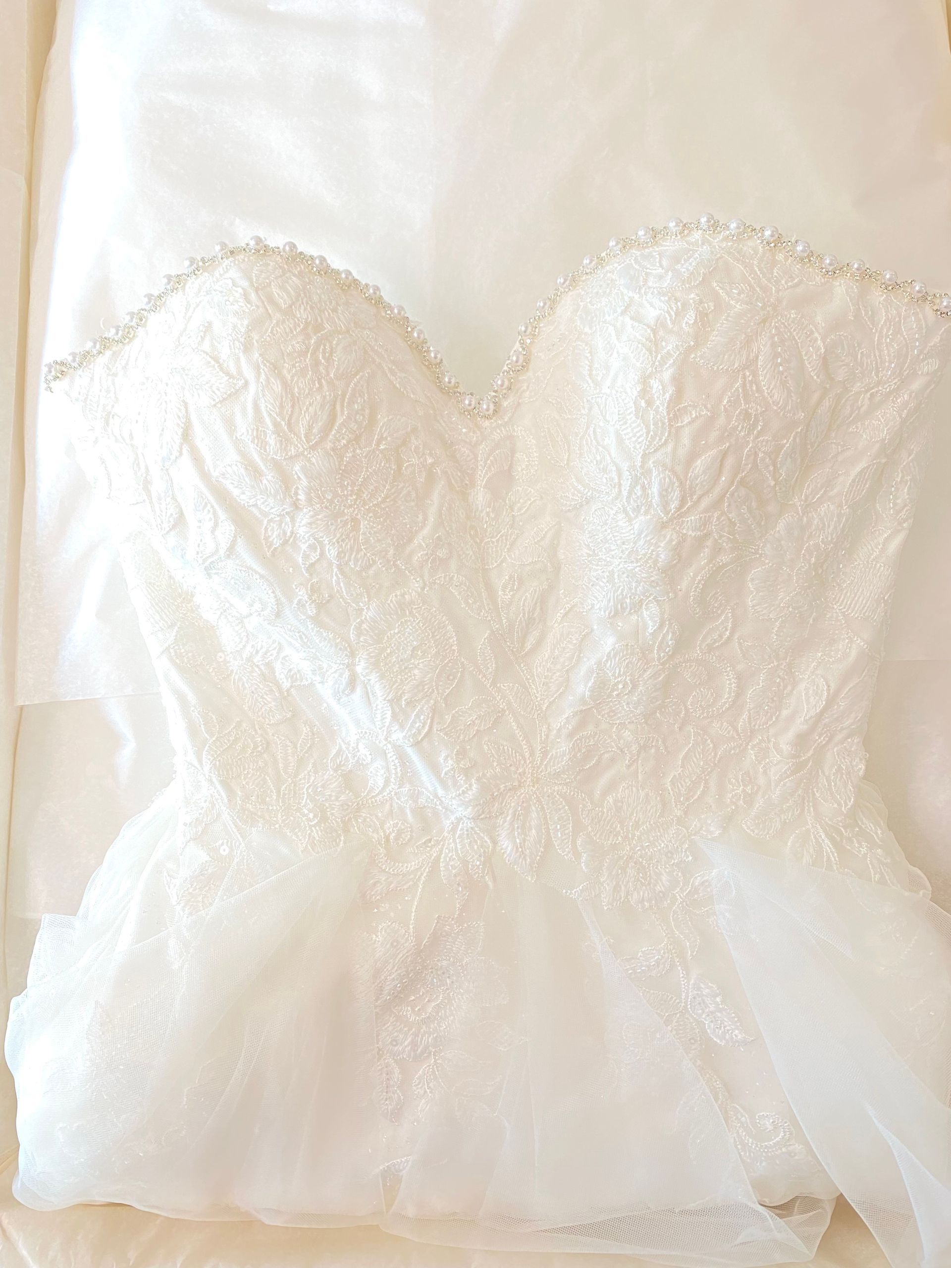 White wedding dress, sweetheart neckline, beaded detail, tulle skirt.