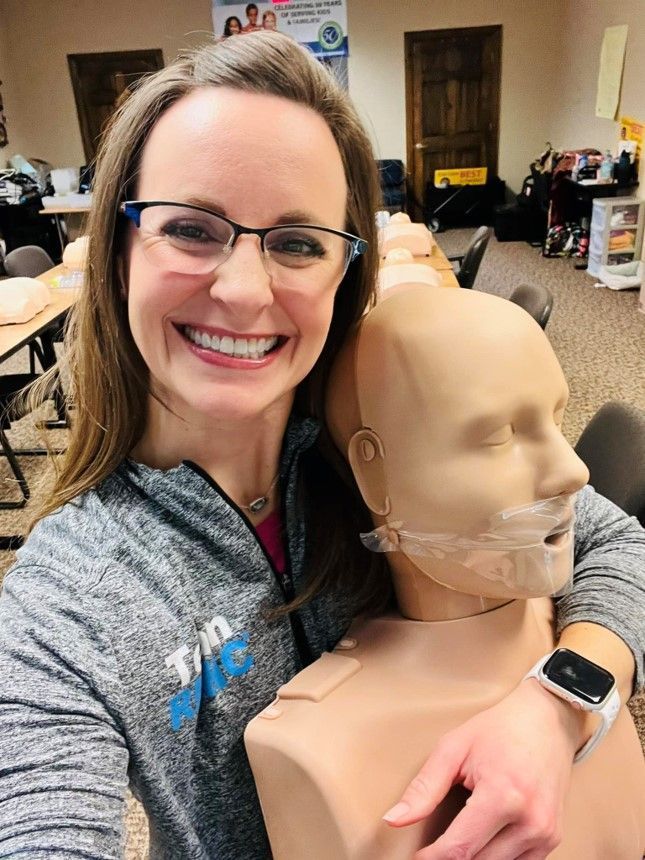 A woman is taking a selfie with a mannequin.