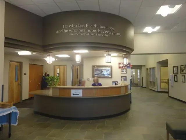 Spacious medical office lobby with a curved reception desk.