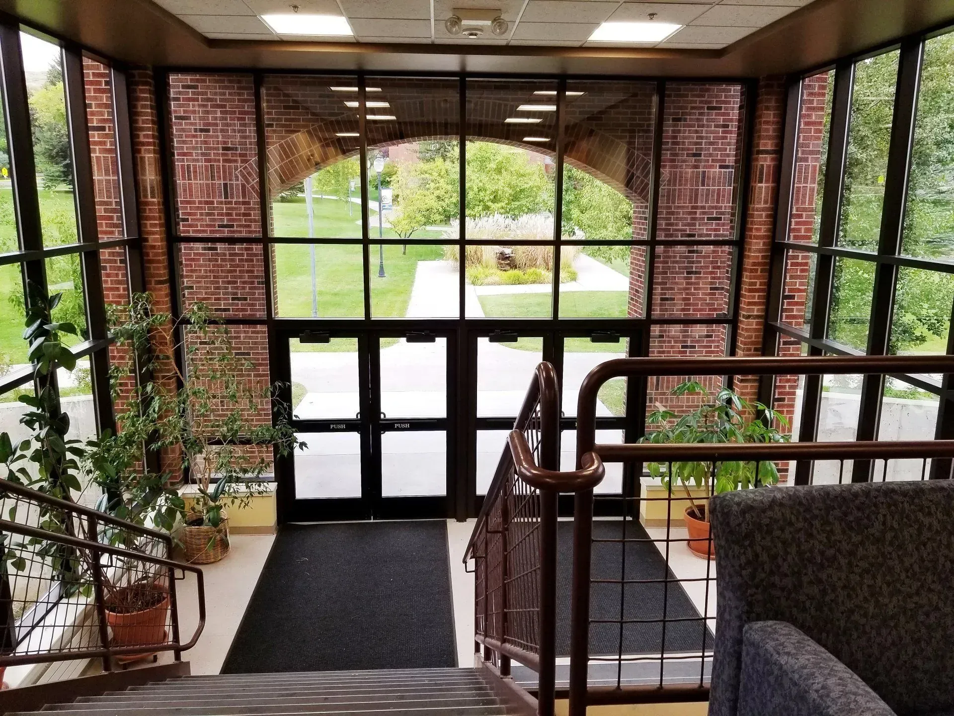 A bright lobby with large windows and glass doors.