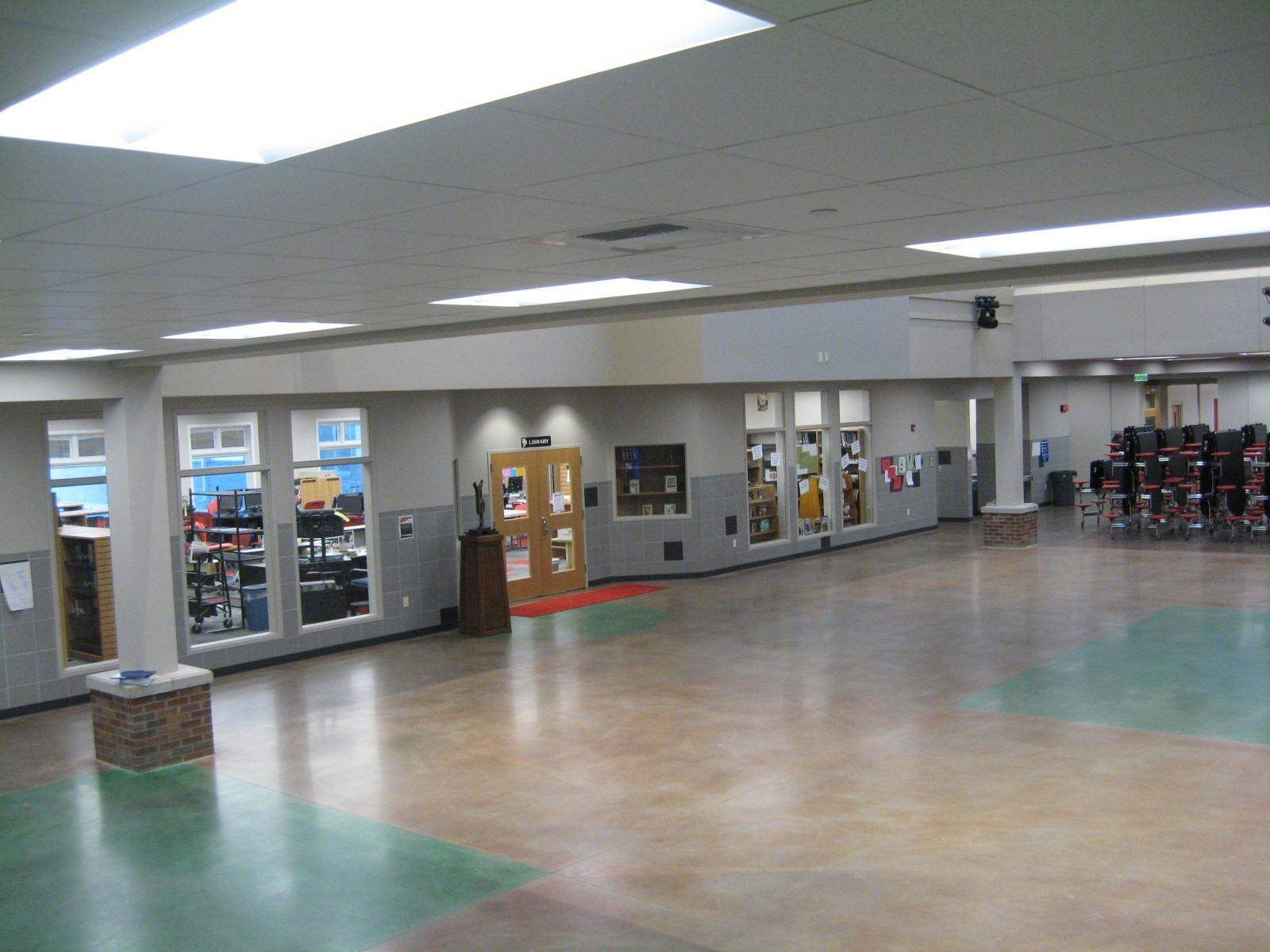 A large room with a lot of windows and a green floor.