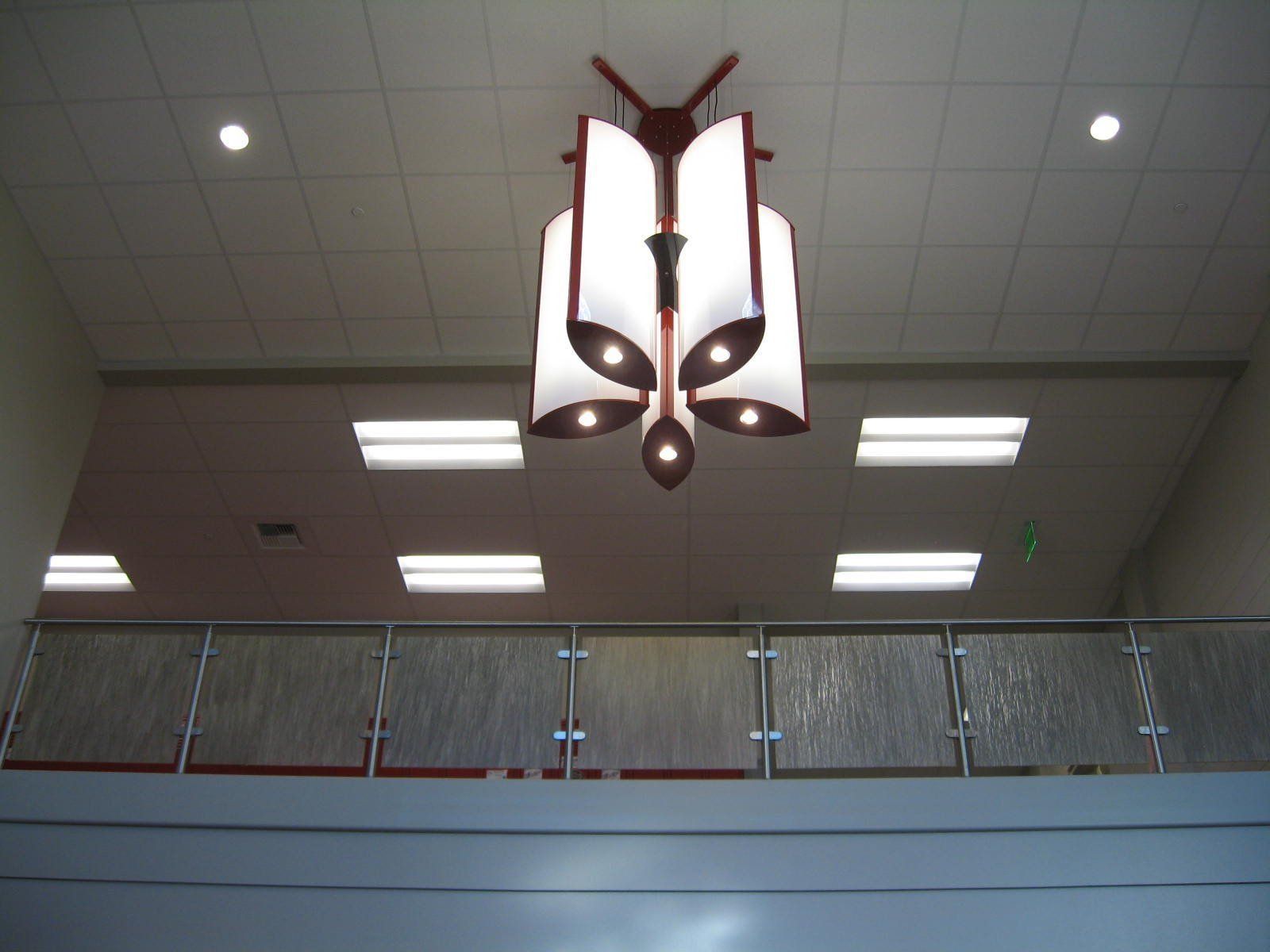 A chandelier in the shape of a book is hanging from the ceiling.