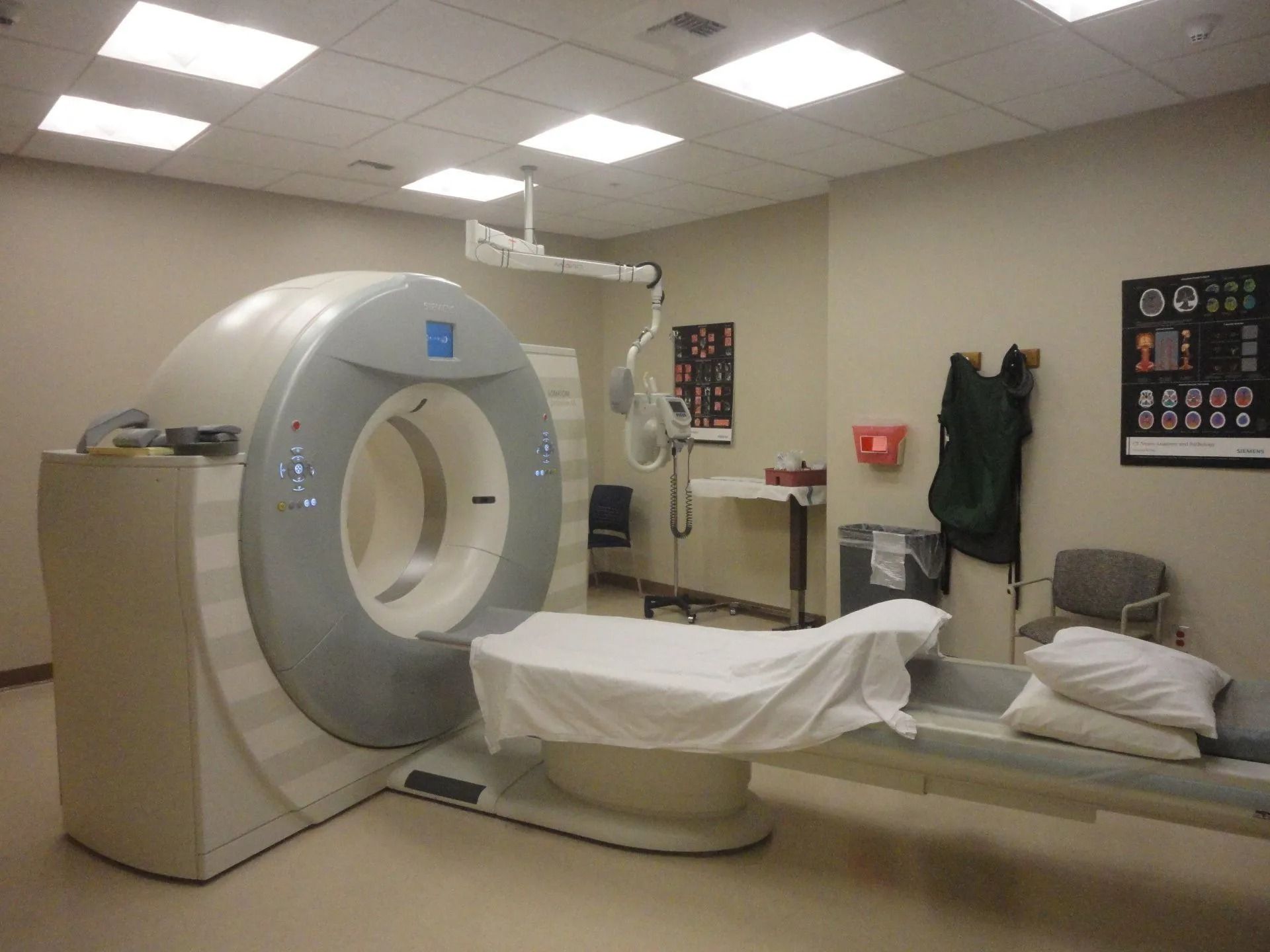 A hospital room with a large CT scan machine.