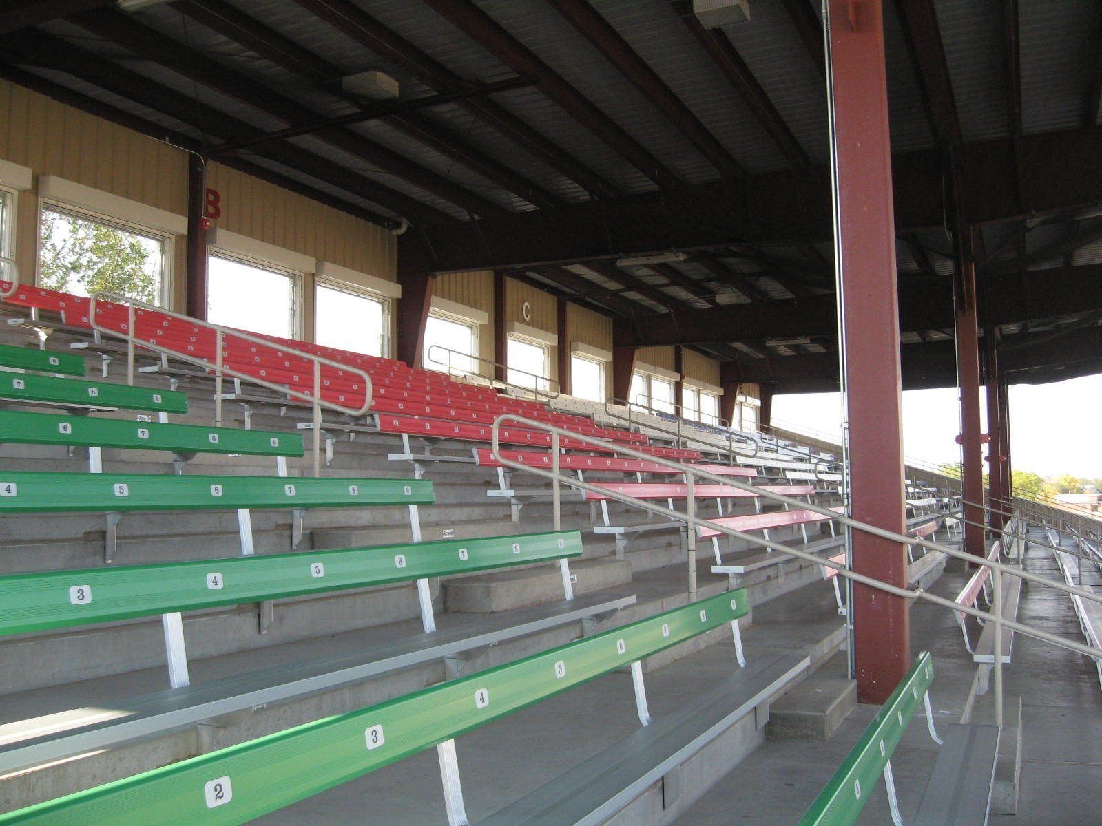 An empty stadium with green and red seats