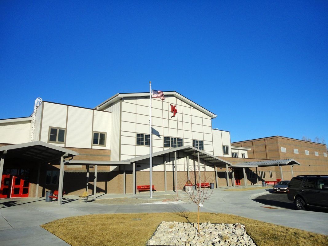 A large building with a lot of windows and a car parked in front of it.