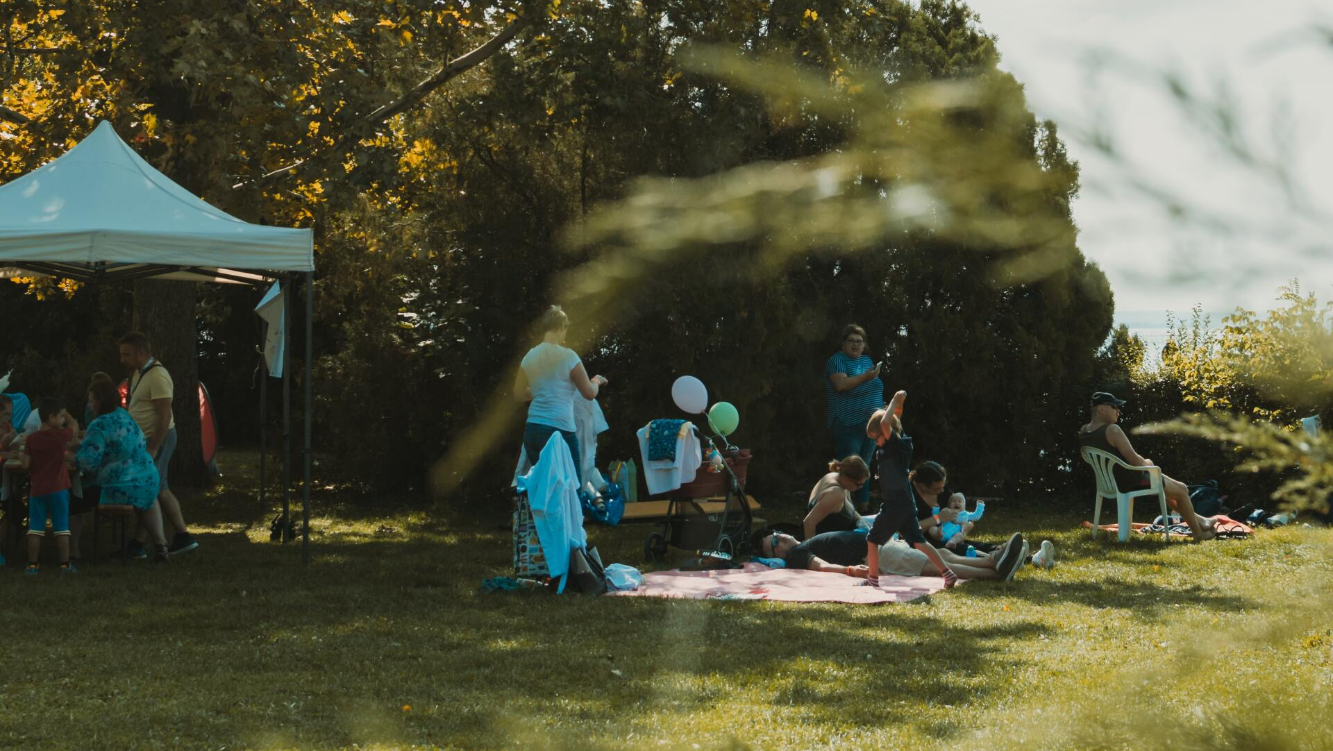 A group of people are having a picnic in a park.