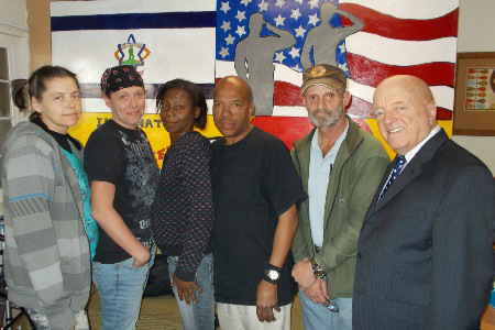 A group of people standing in front of an american flag
