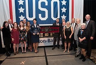 A group of people standing in front of a usa banner
