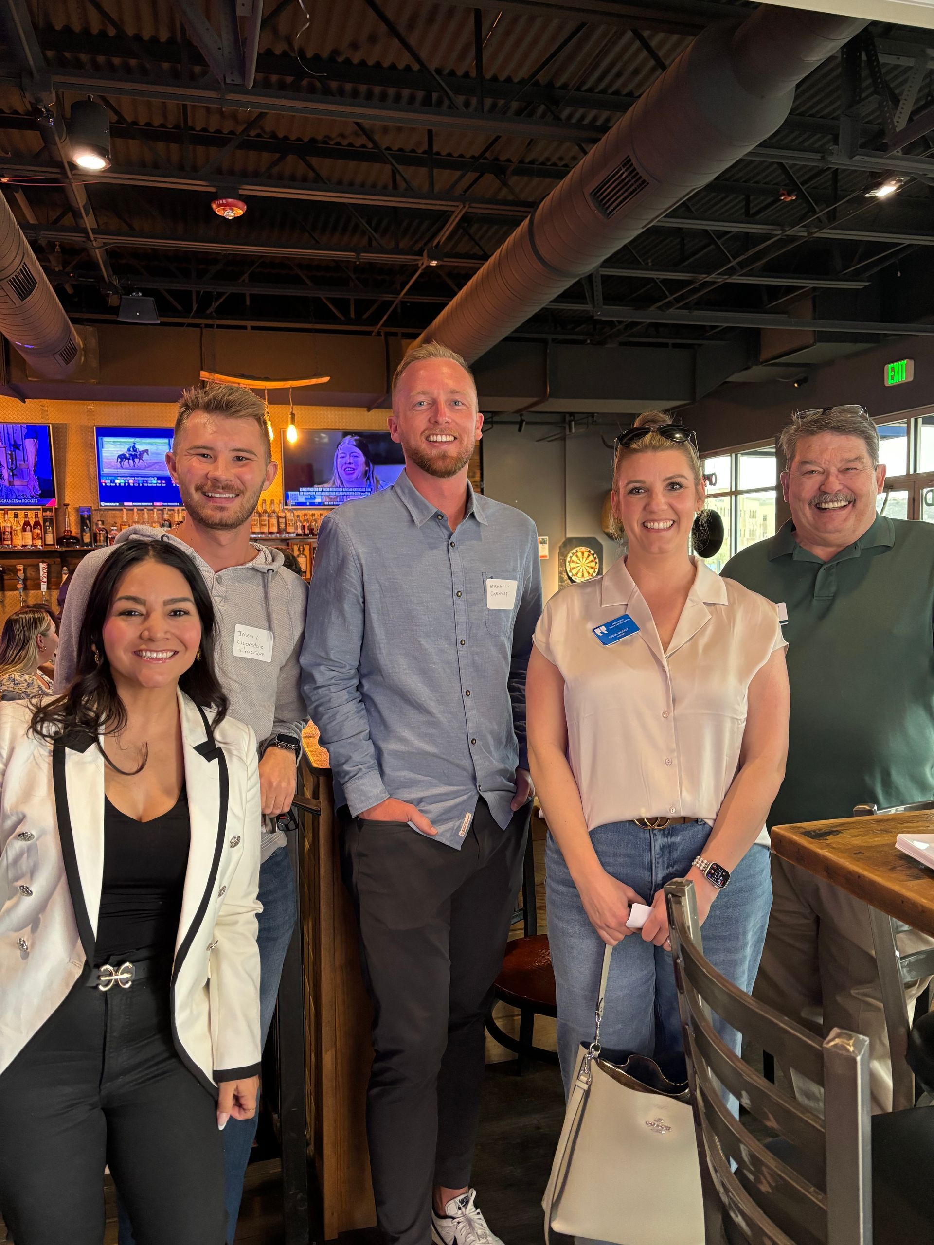 A group of people are posing for a picture in a restaurant.
