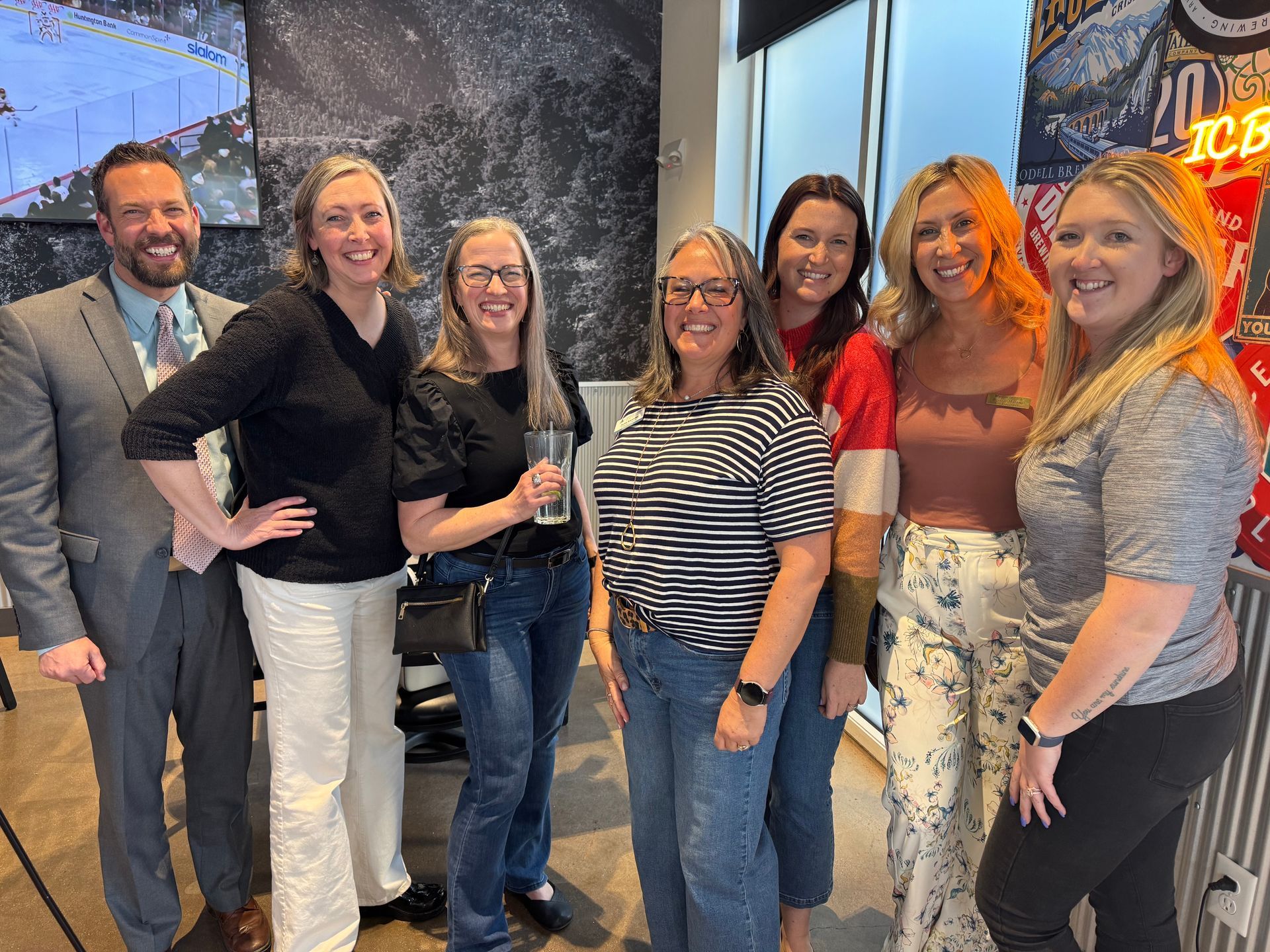 A group of people are posing for a picture together in a room.