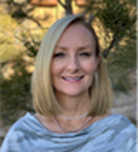 A woman with blonde hair is smiling for the camera.