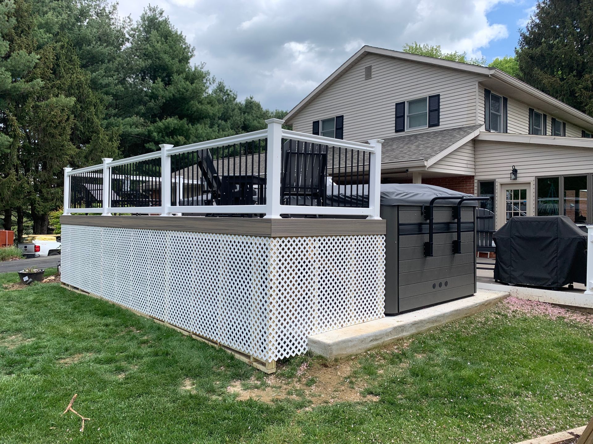 Remodeling Experts deck builder contractor custom deck along pool. Deck details... maintenance free composite decking with white vinyl railing 