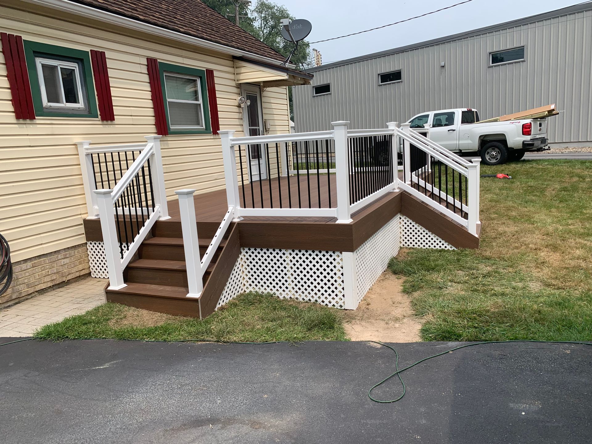 Remodeling Experts deck builder contractor custom deck along pool. Deck details... maintenance free composite decking with white vinyl railing 
