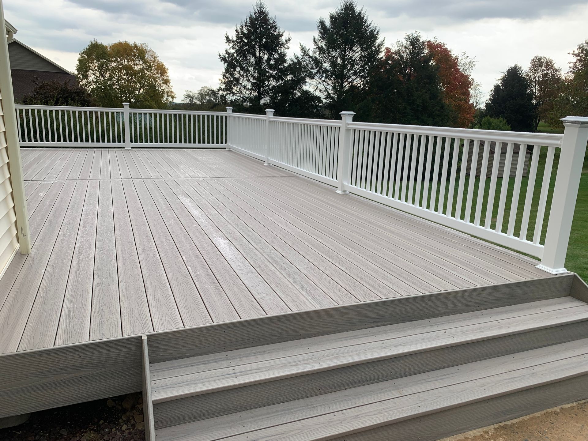 Remodeling Experts deck builder contractor custom deck along pool. Deck details... maintenance free composite decking with white vinyl railing 
