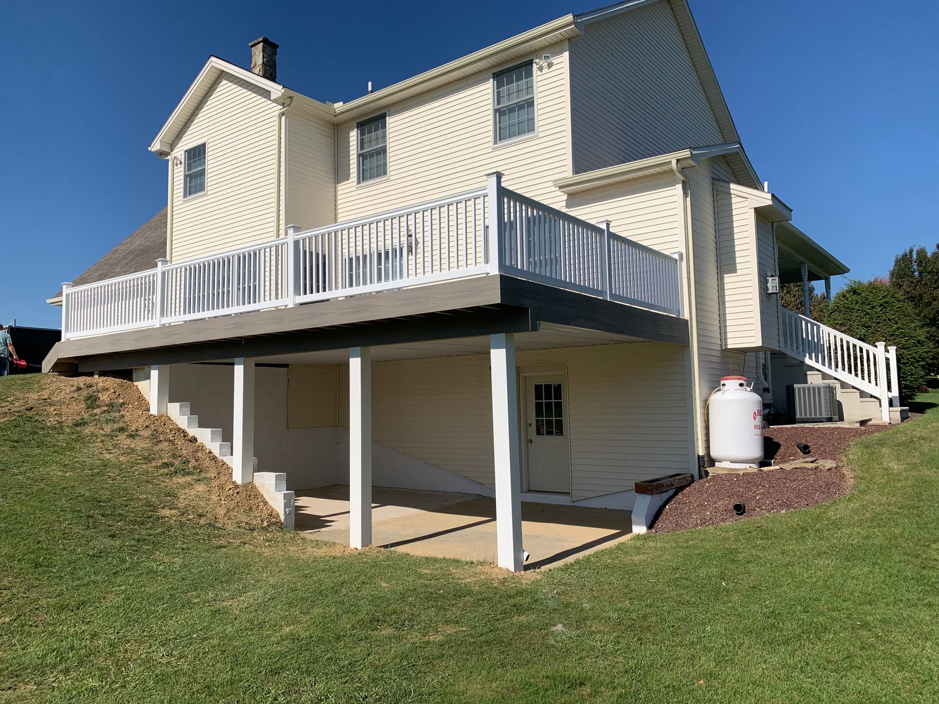 Remodeling Experts deck builder contractor custom deck along pool. Deck details... maintenance free composite decking with white vinyl railing 