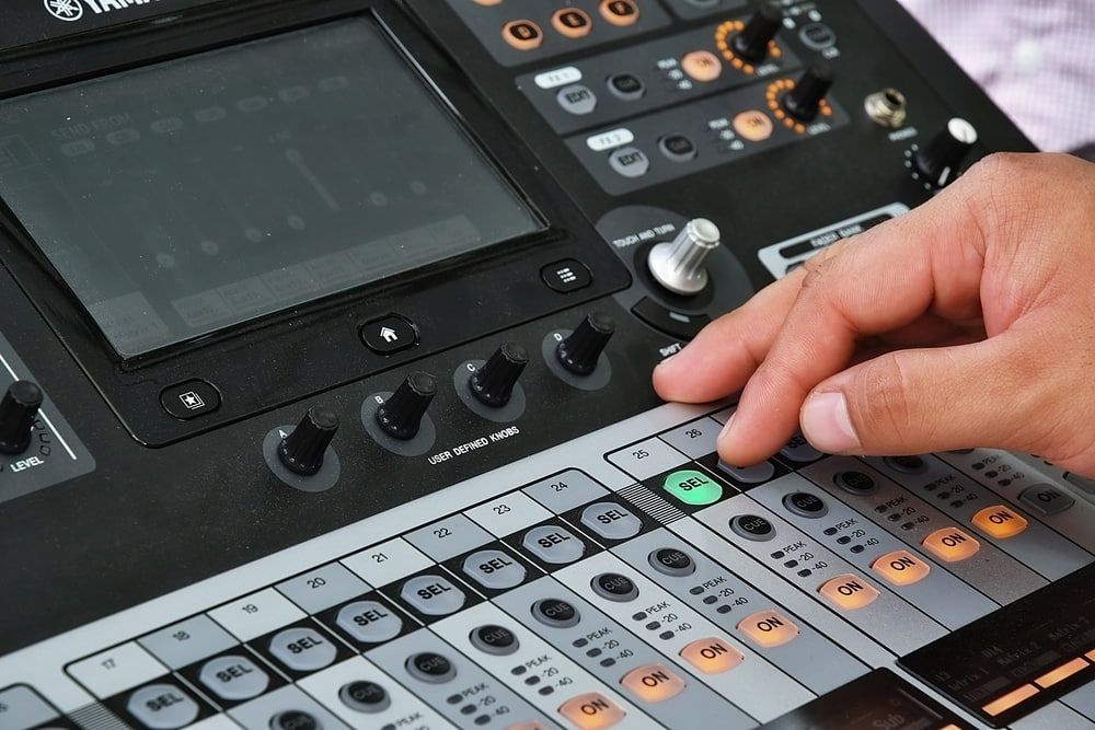 A Person is Pressing a Button on a Control Panel — Inspired Audio Visual in Coffs Harbour, NSW