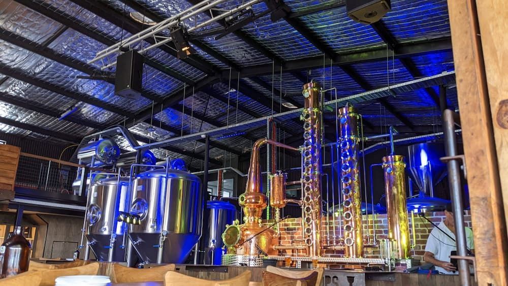 A Man is Standing in a Room With a Lot of Machinery in It — Inspired Audio Visual in Coffs Harbour, NSW