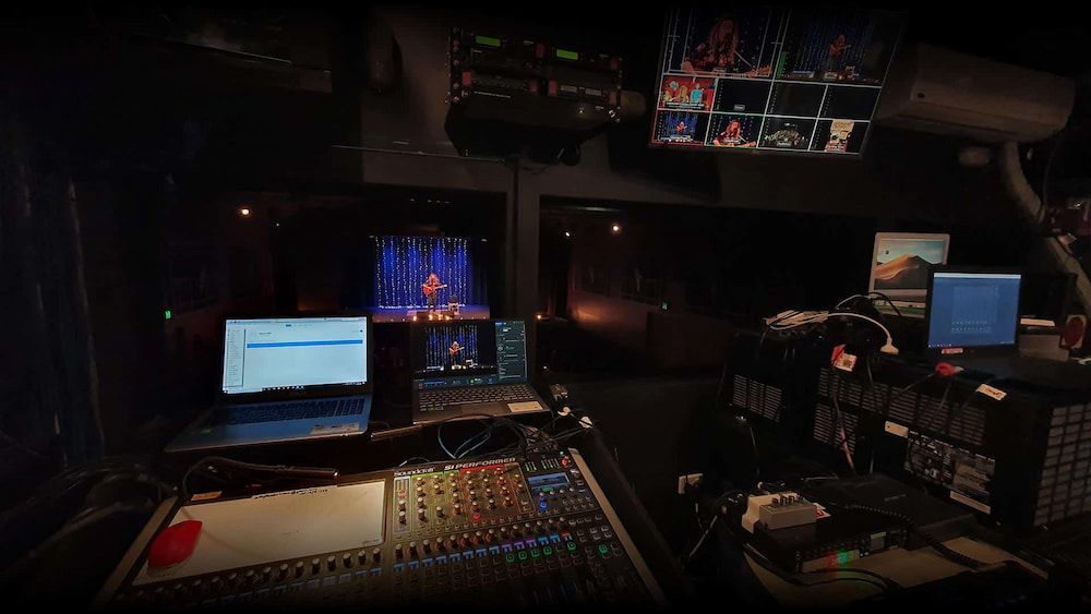 A Dark Room With a Mixer and a Laptop on It — Inspired Audio Visual in Coffs Harbour, NSW
