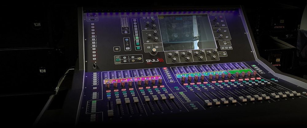 A Mixer With a Lot of Buttons and Knobs is Sitting on a Table in a Dark Room — Inspired Audio Visual in Coffs Harbour, NSW