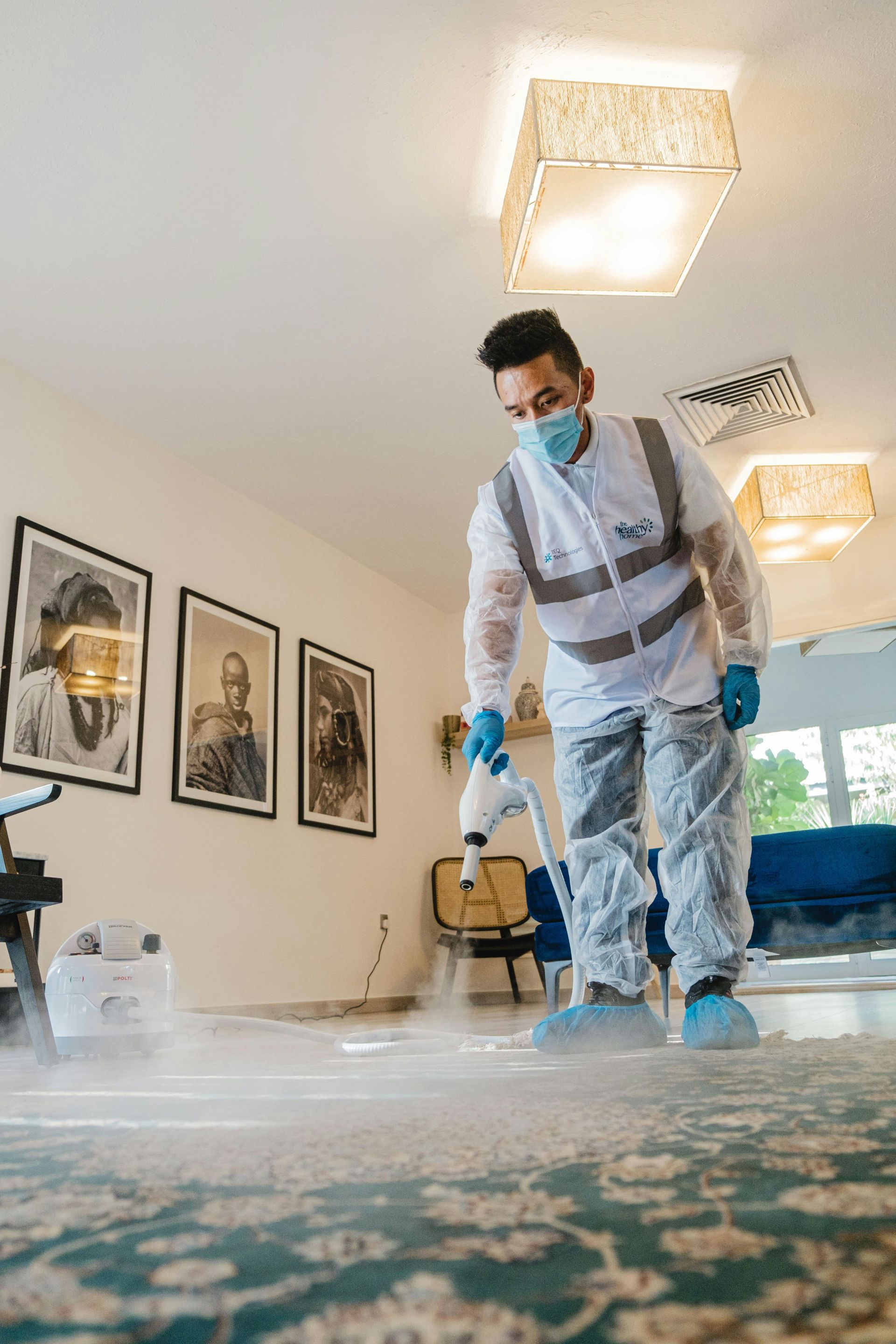 Based on the image showing a professional cleaner in protective gear working in a home interior.