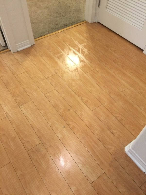 A wooden floor with a light shining on it in a room.