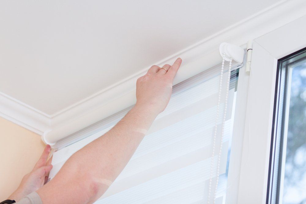 Man Hands Installing Window Roller Duo System Day And Night — Co-ordinations Blinds & Awnings in Falls Creek, NSW