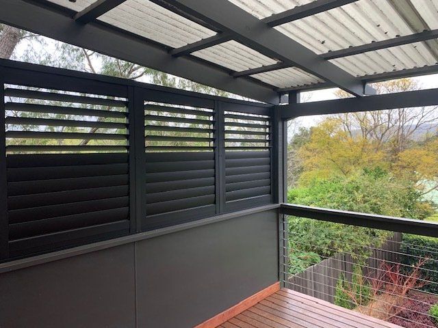 Black Canvas Awning In Front Of Shop — Co-ordinations Blinds & Awnings in Falls Creek, NSW