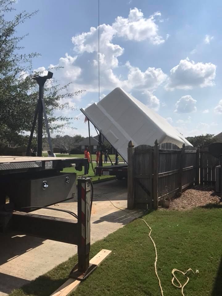 A White Coated Pool is Being Lifted by a Crane - Madison, AL - Valley Pools