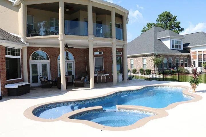 A Large House With a Large Swimming Pool in Front of It - Madison, AL - Valley Pools