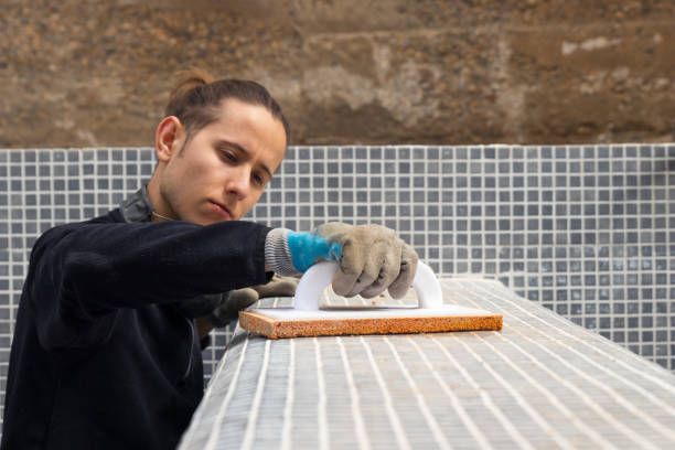 Image of a contractor working on the construction of a swimming pool.