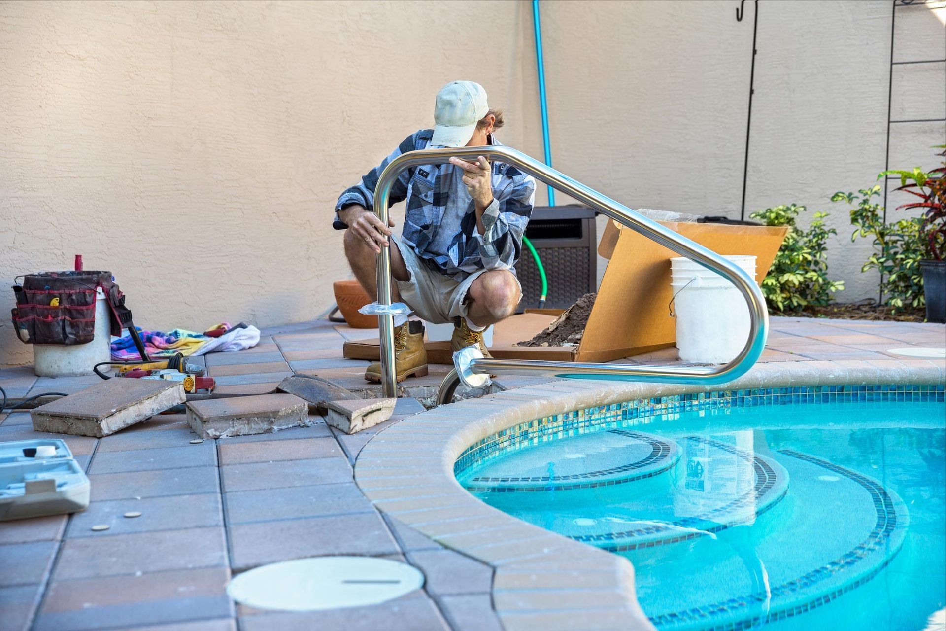 A man repairs a backyard pool in Decatur, AL, showcasing Valley Pools' expertise as Swimming Pool Co