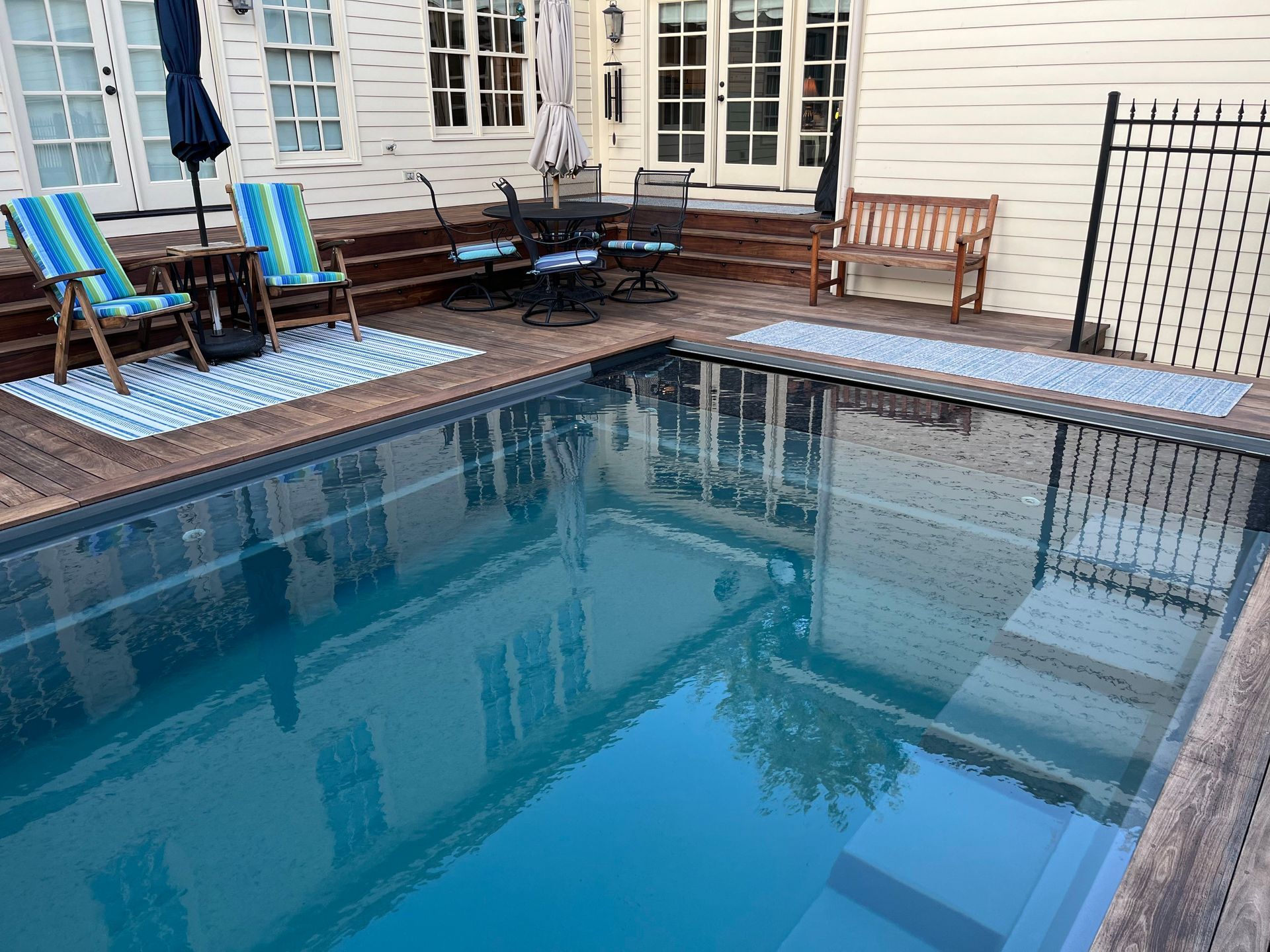 There is a large swimming pool in the backyard of a house. - Madison, AL - Valley Pools