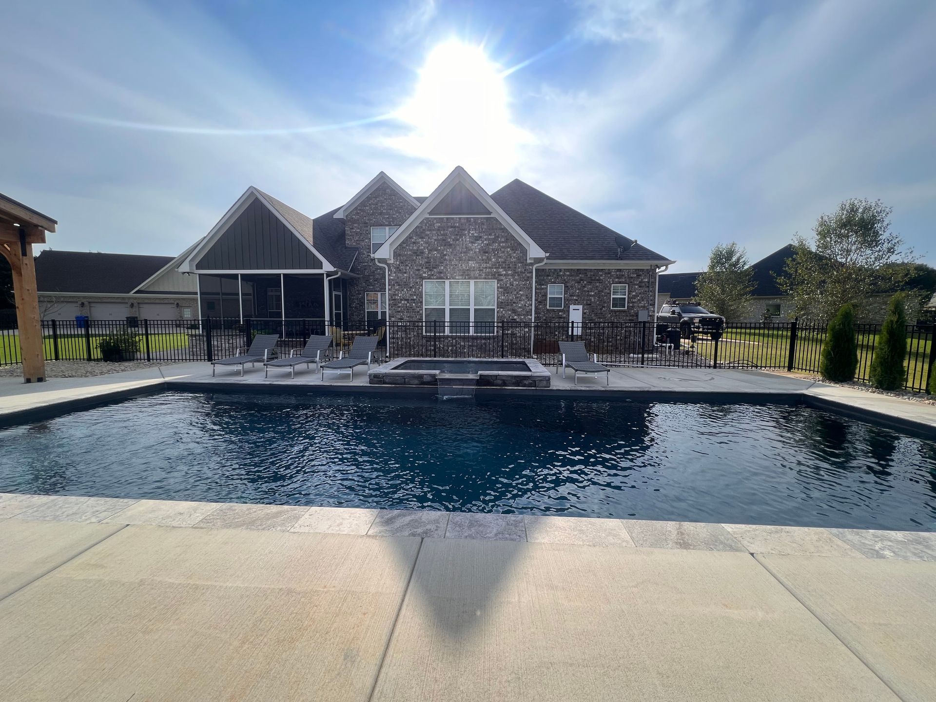 A large house with a large swimming pool in front of it - Madison, AL - Valley Pools