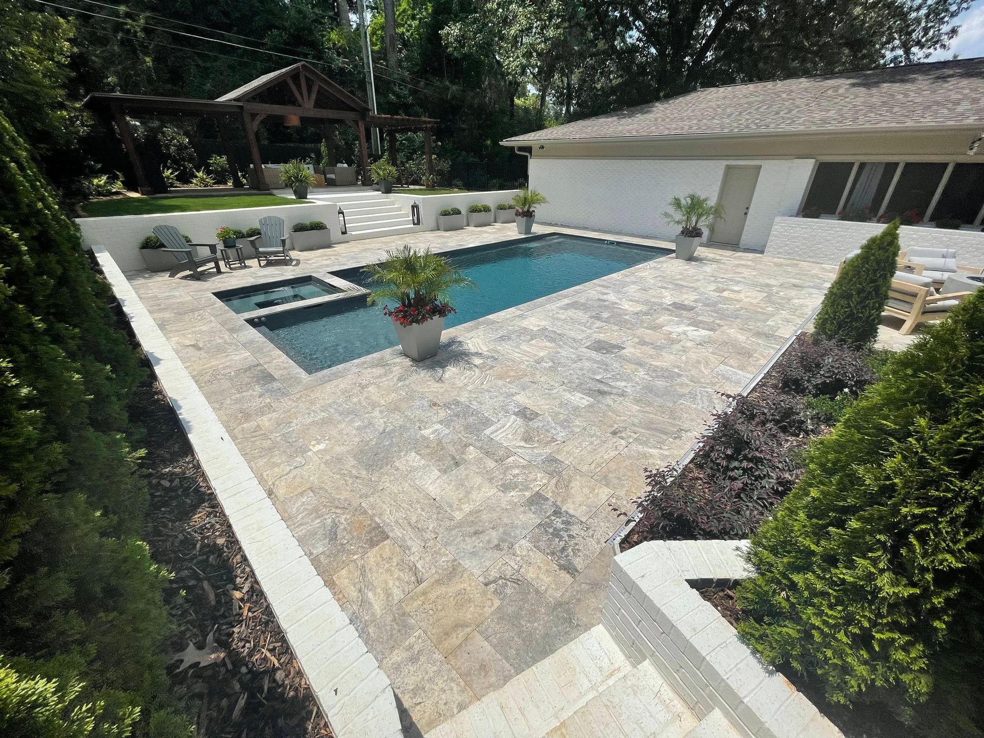 A large swimming pool is in the backyard of a house - Madison, AL - Valley Pools