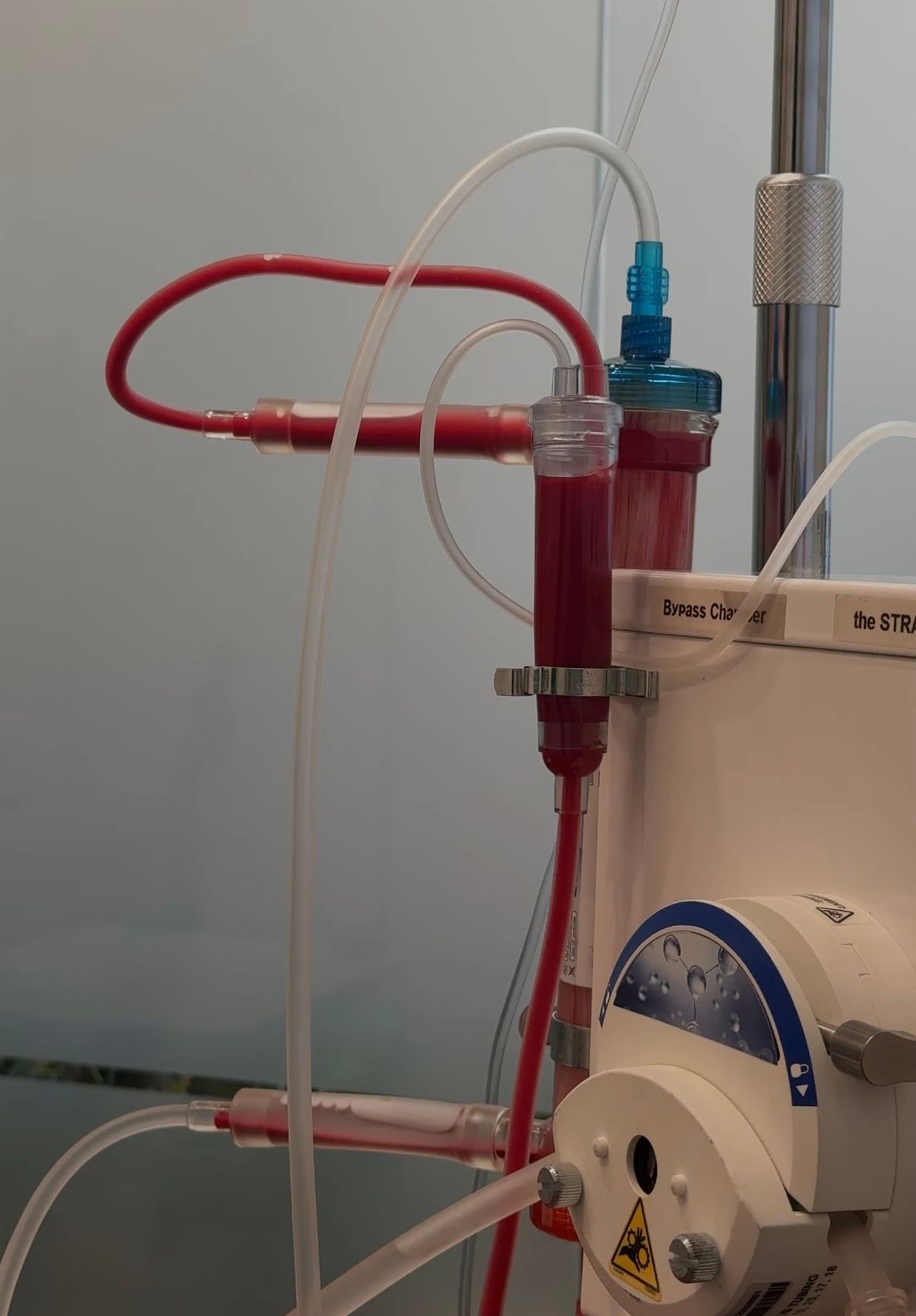 Woman in black sportswear stretching arms overhead against a blue sky with clouds.