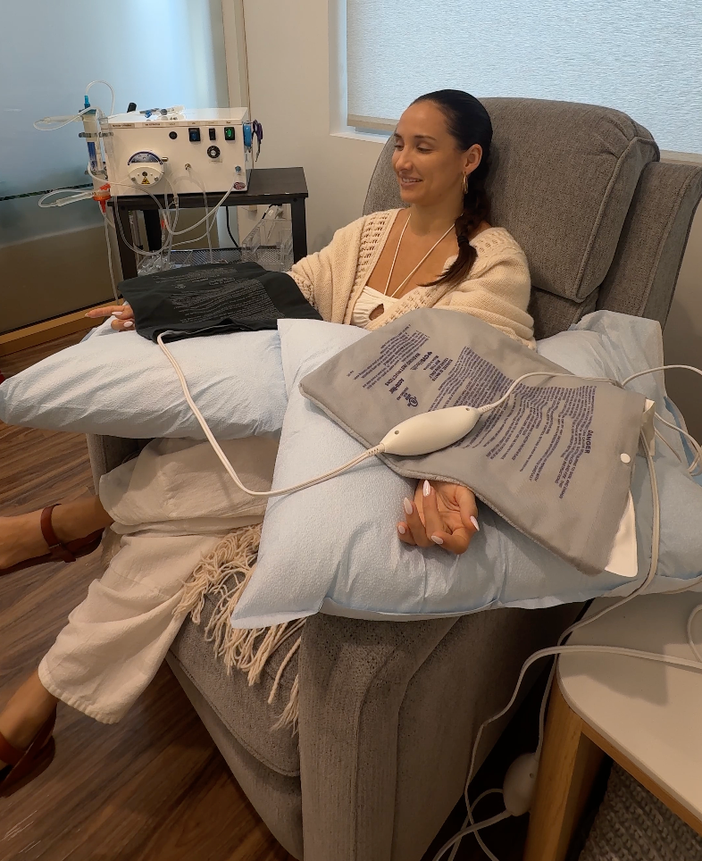 Person drawing blood from their wrist with a syringe; red blood visible.