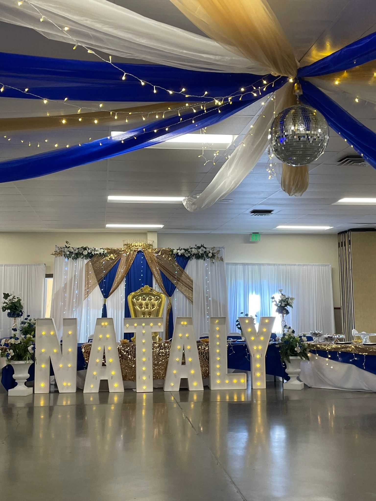 Party decorations with illuminated letters spelling 