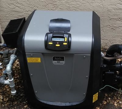 A gray and black machine with a yellow warning sign on it