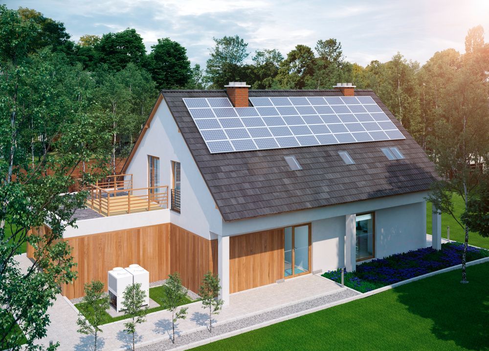 An aerial view of a house with solar panels on the roof.