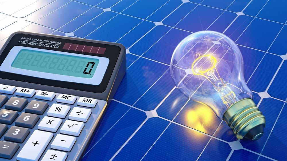 A calculator and a light bulb on a solar panel